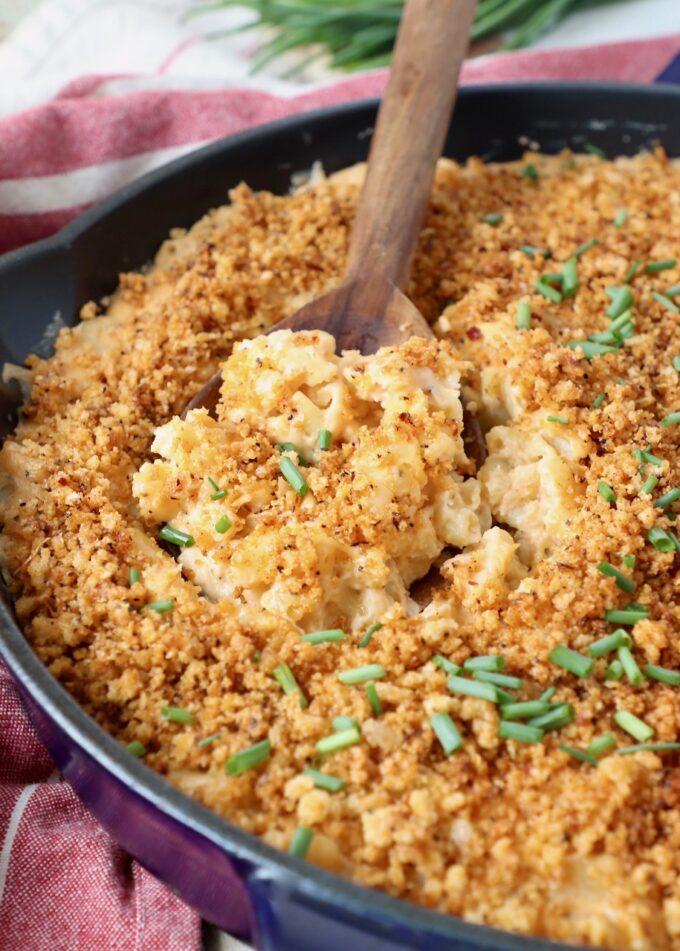 smoked mac and cheese in skillet with serving spoon