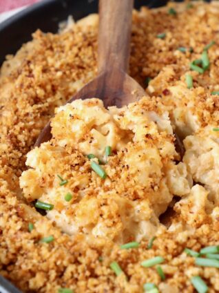 mac and cheese in skillet with serving spoon