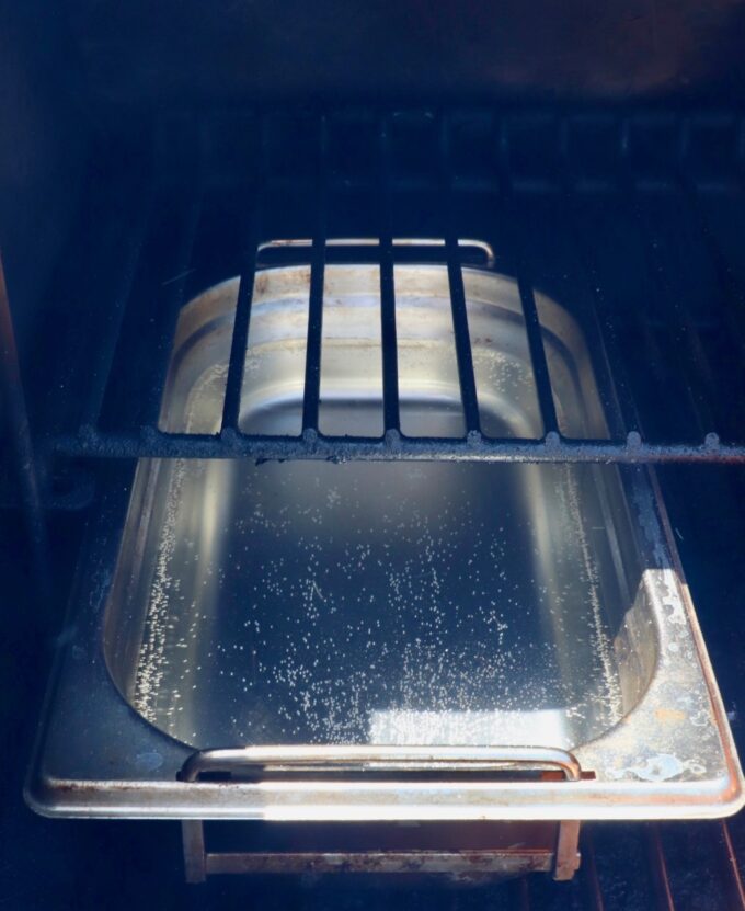 pan filled with water in a smoker