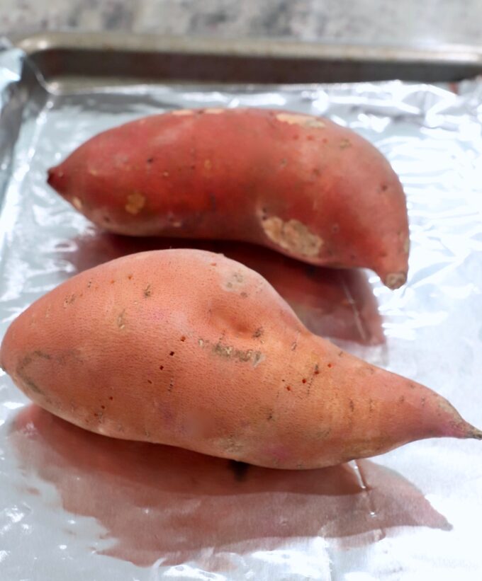 sweet potatoes on foil lined baking sheet