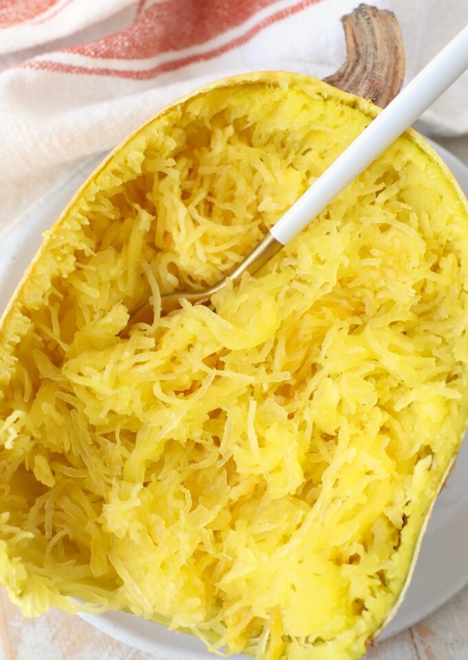 microwaved spaghetti squash half on plate with fork