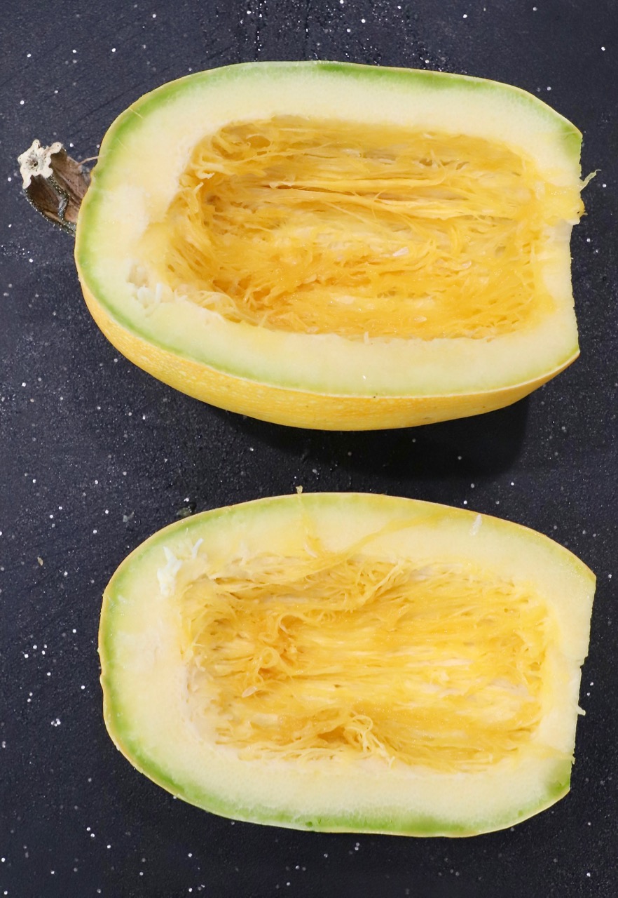 spaghetti squash cut in half on cutting board