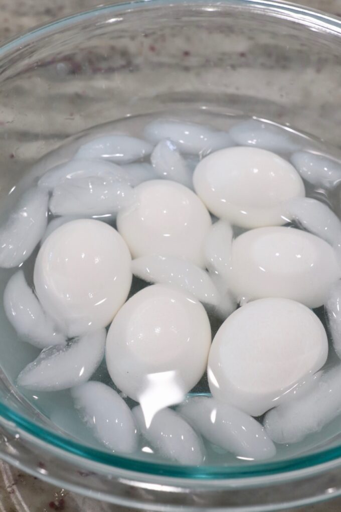 hard boiled eggs in glass bowl of ice water