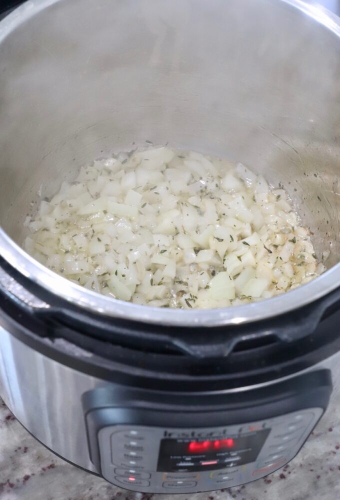 diced onions and garlic in Instant Pot