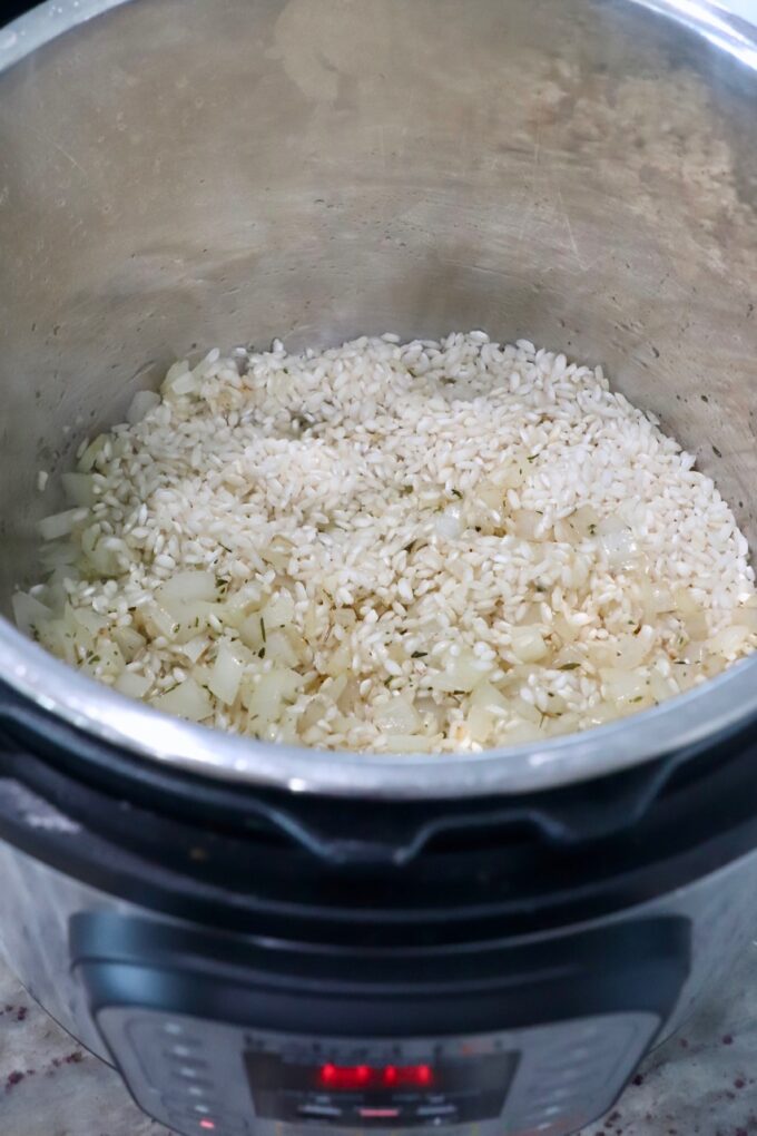 arborio rice in Instant Pot with cooked onions