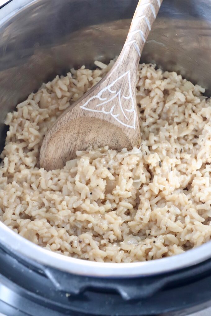 cooked risotto in Instant Pot with serving spoon