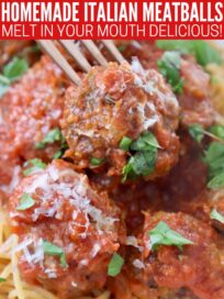 cooked meatballs in marinara sauce on fork
