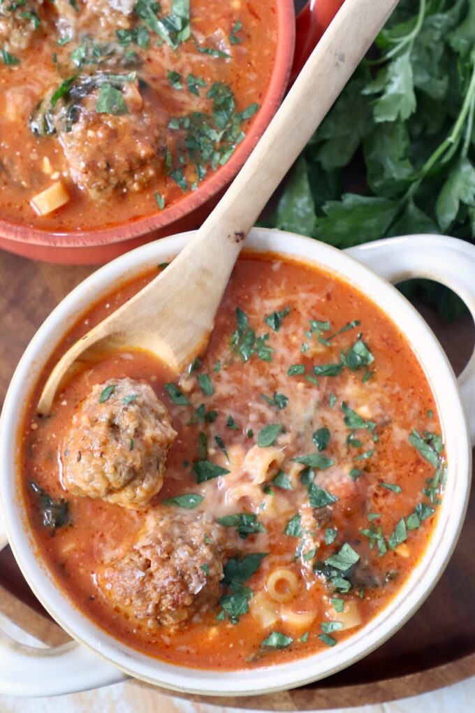 meatball soup in bowls with wooden spoon