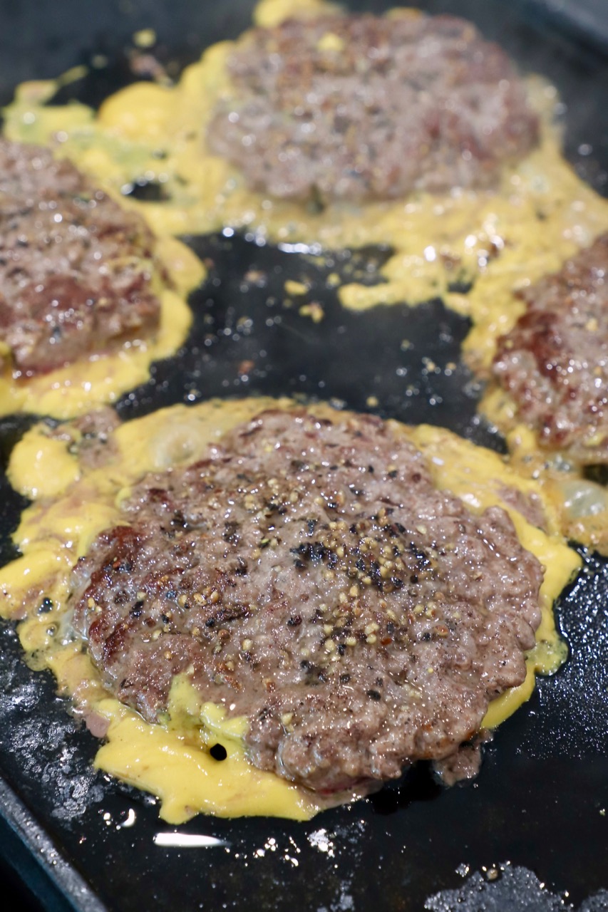 cooked burger patties on griddle