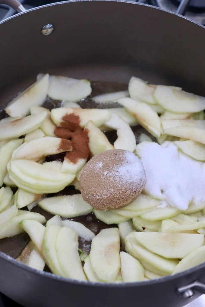 apples in pan with sugar and cinnamon