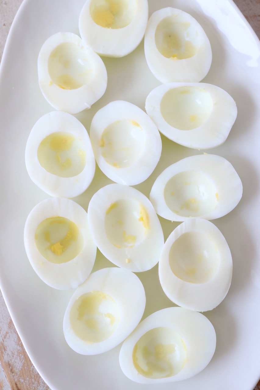 hard boiled egg whites on plate with the yolks removed