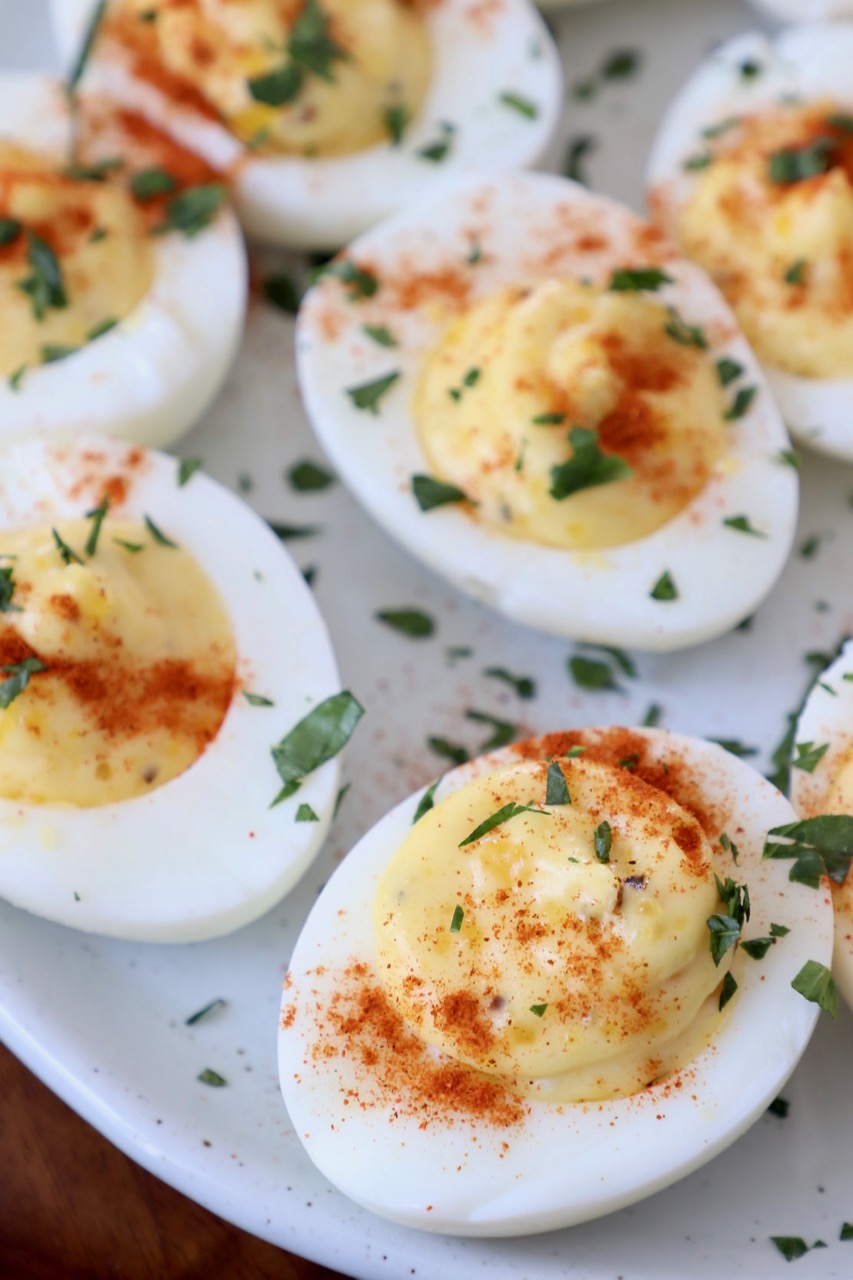 deviled eggs on plate topped with fresh chopped parsley