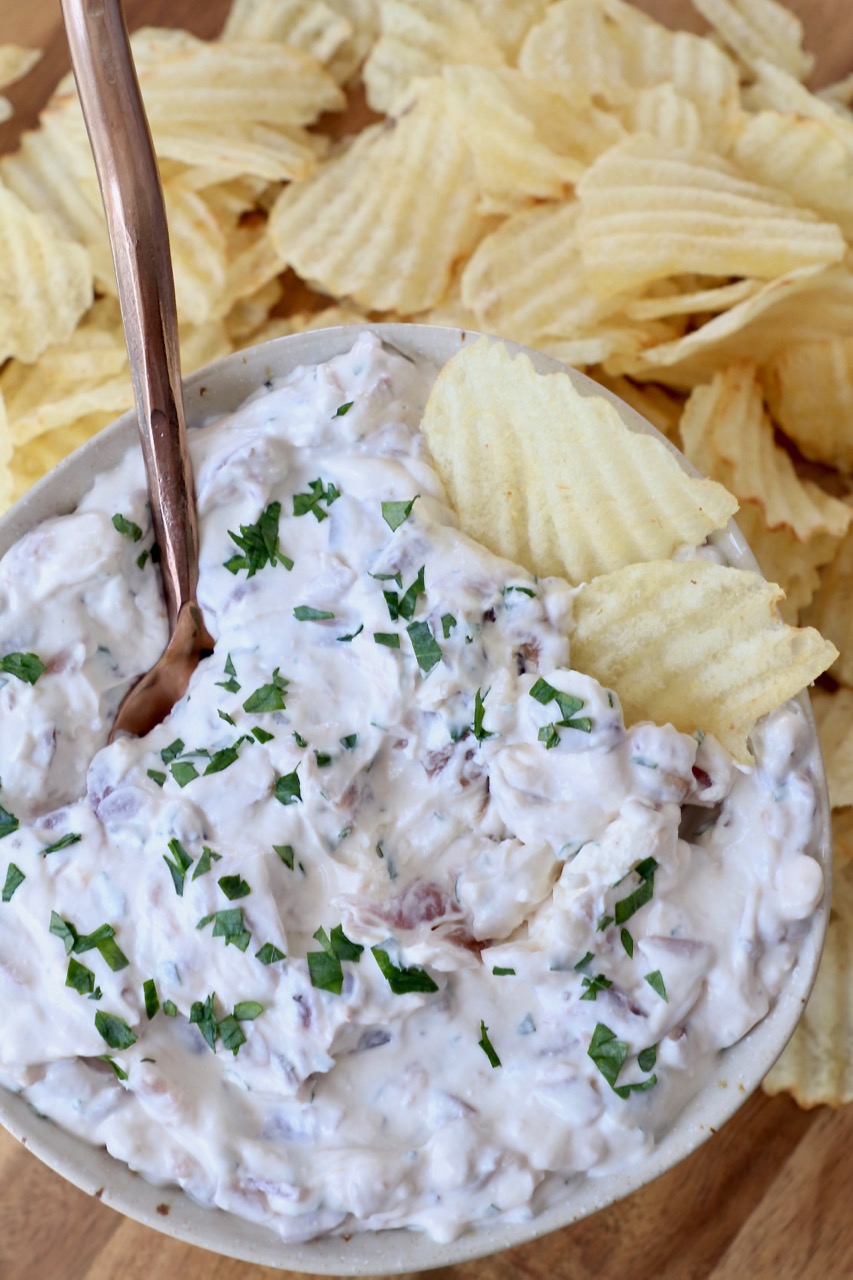 french onion dip in bowl with ruffles potato chips