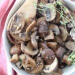 sauteed mushrooms in bowl with wooden spoon