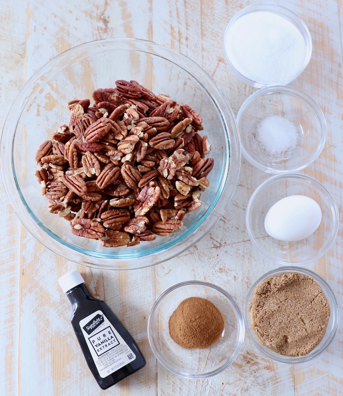 ingredients for candied pecans on white wood board
