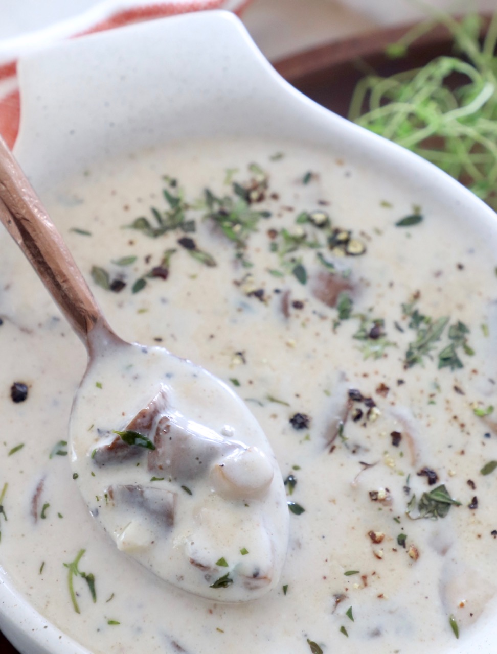 creamy mushroom soup in bowl with spoon