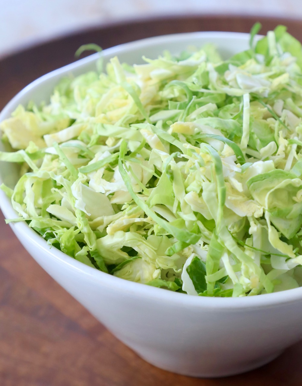 shredded brussels sprouts in white bowl