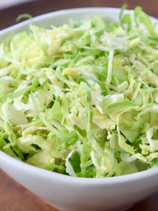 shredded brussels sprouts in white bowl