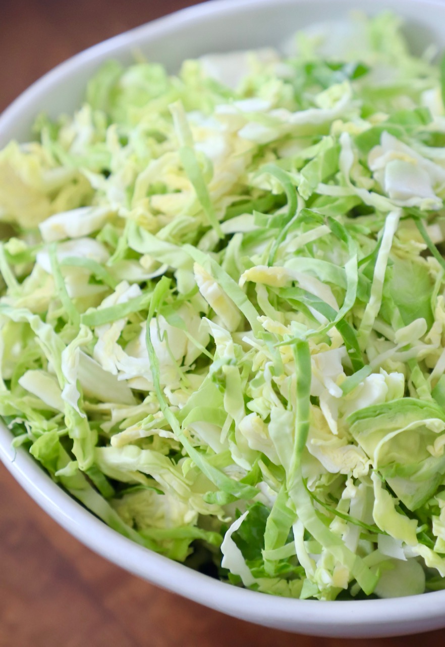 shredded brussel sprouts in white bowl