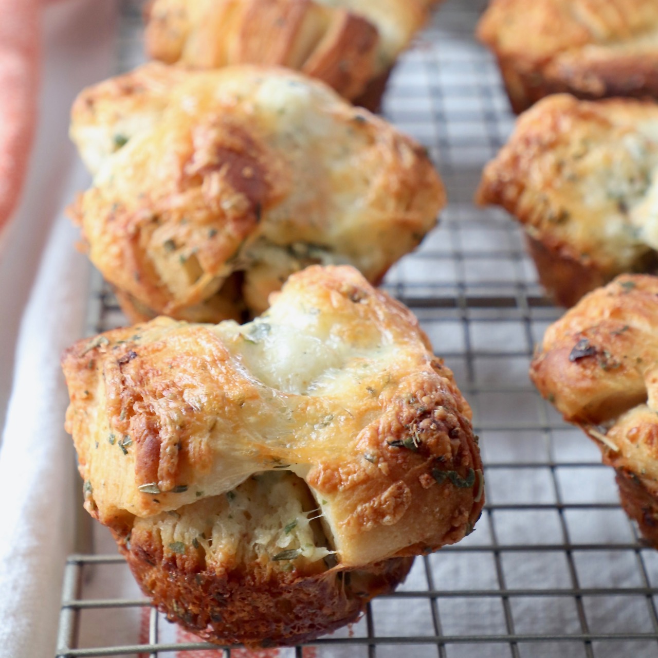 baked pull apart rolls sitting on wire cooling rack