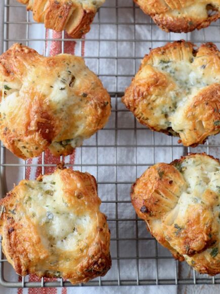 baked cheesy rolls on wire cooling rack