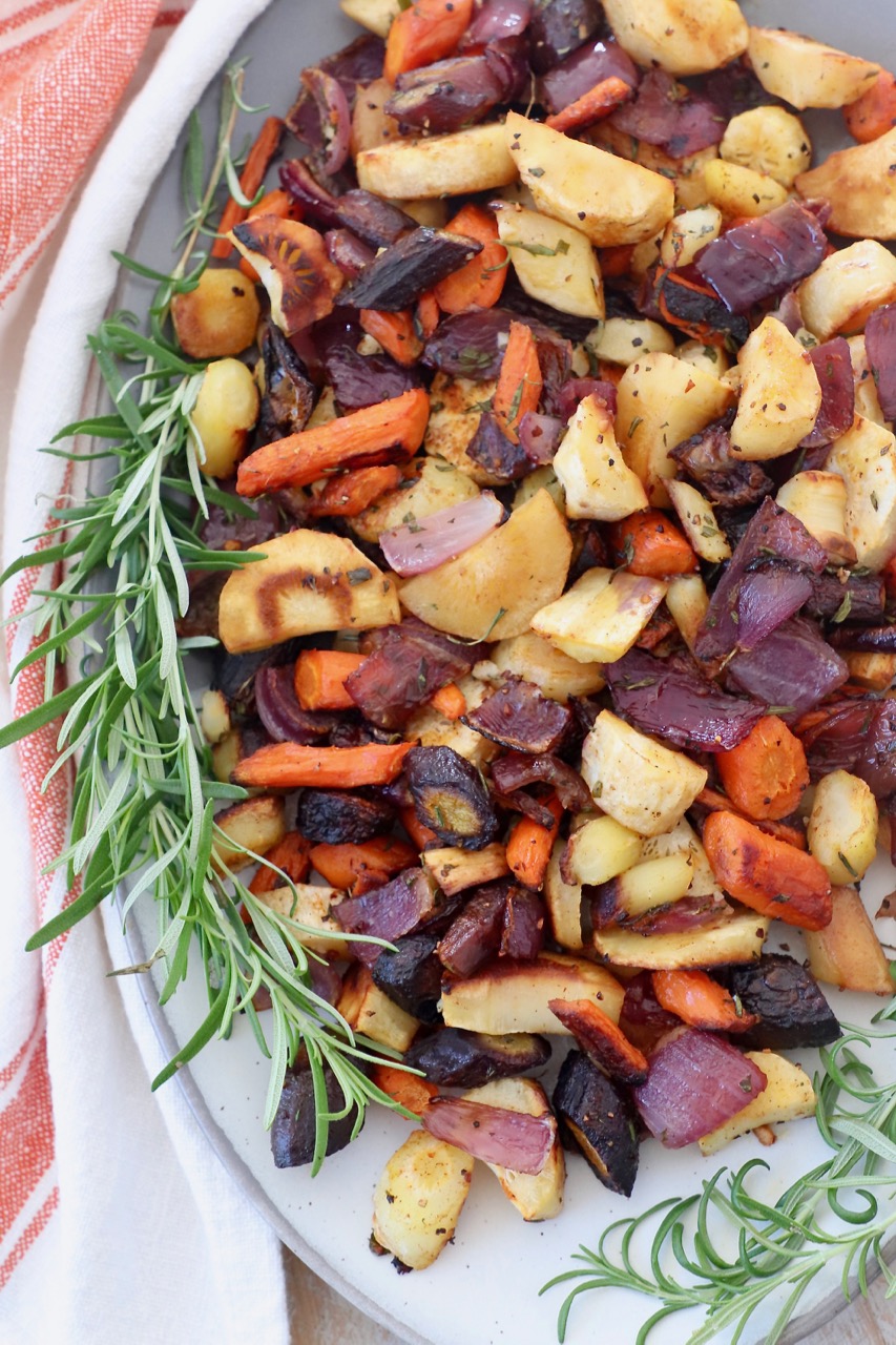 roasted root vegetables on plate with fresh rosemary sprigs