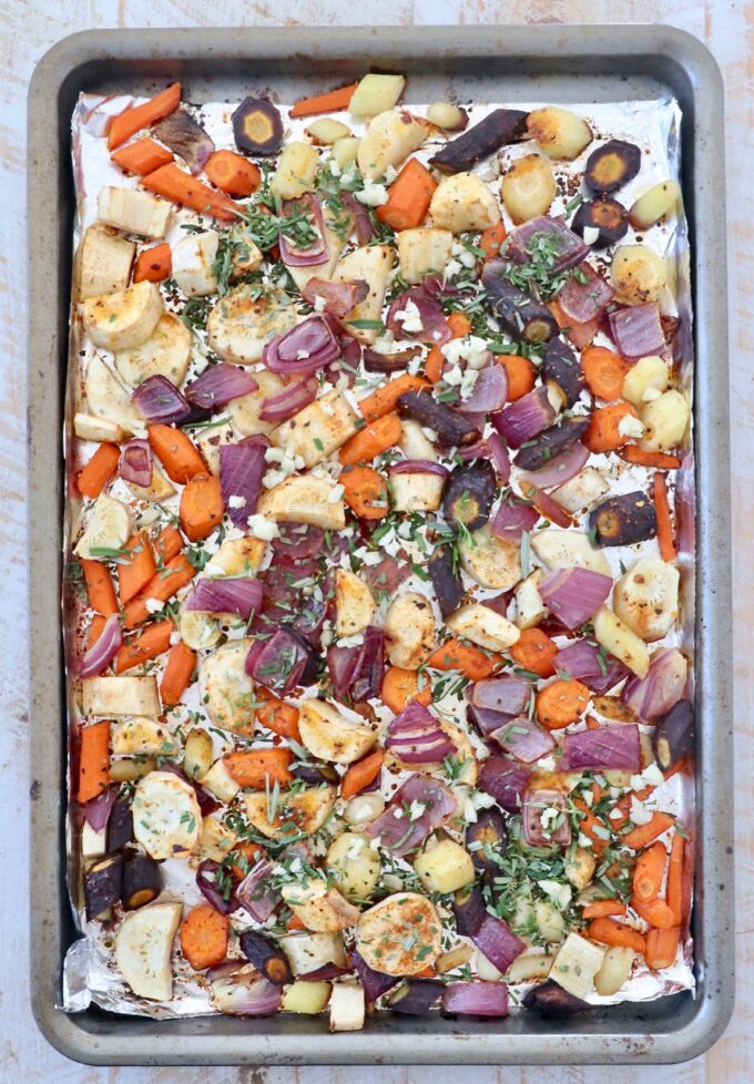 diced vegetables on baking sheet with fresh chopped rosemary