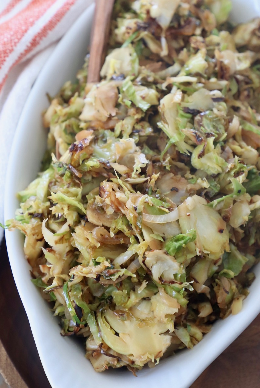 sauteed shredded brussels sprouts in white serving dish with fork