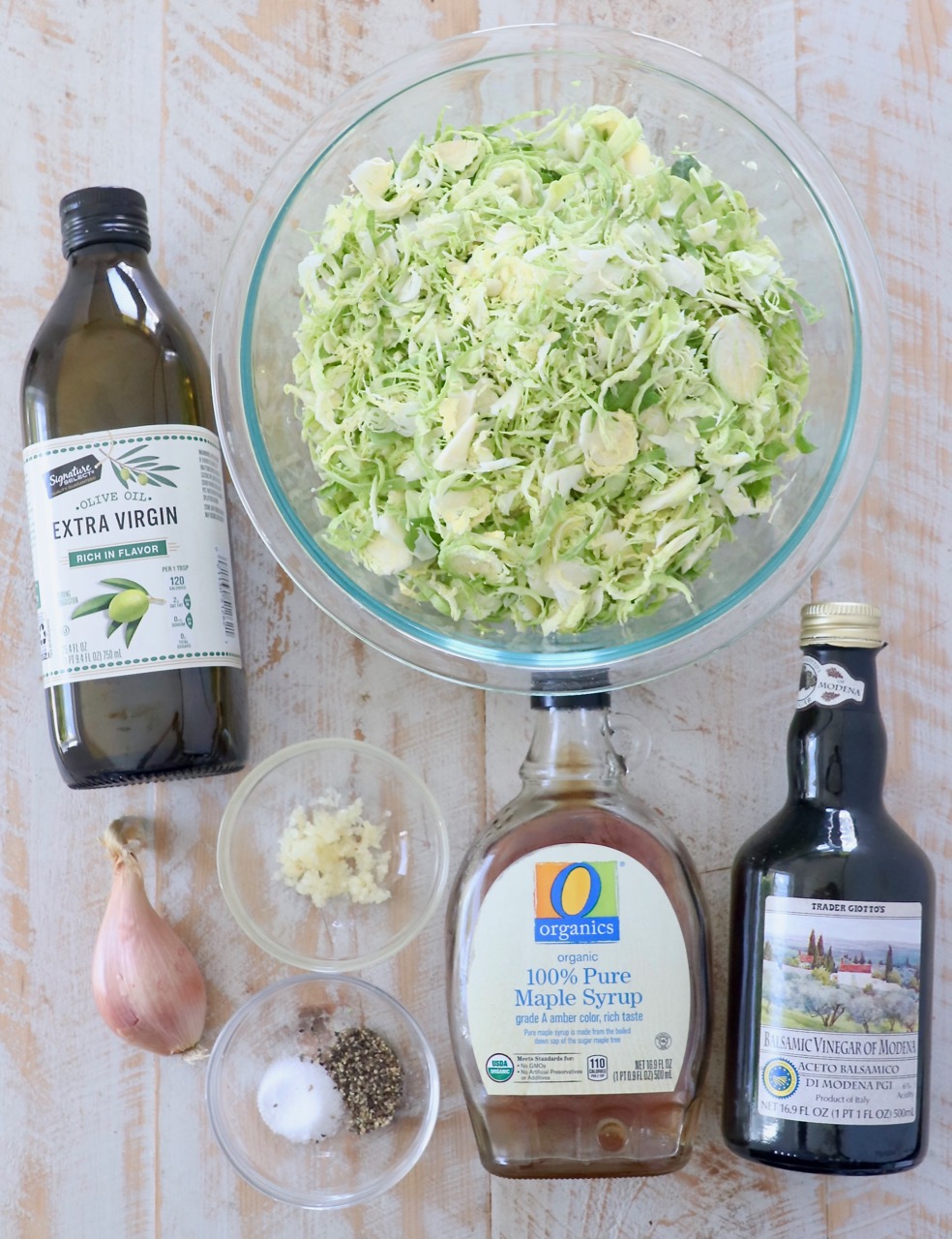 ingredients for sauteed shaved brussels sprouts on white wood board