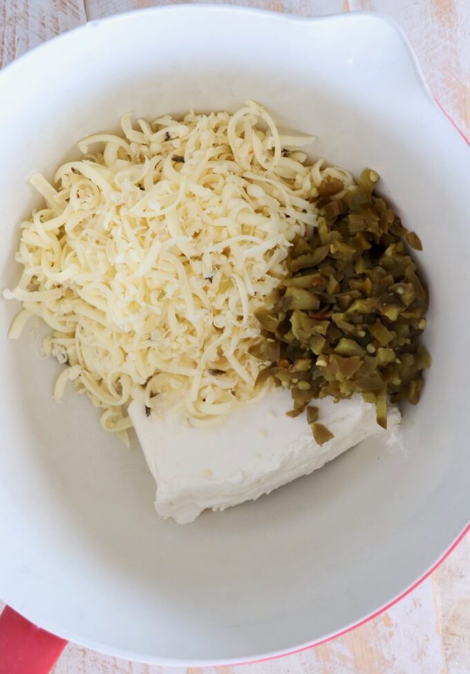 cream cheese, shredded cheese and diced jalapenos in mixing bowl