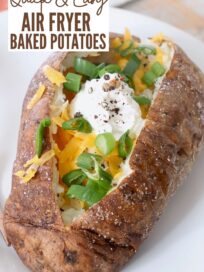 baked potato on plate filled with sour cream, cheese and green onions
