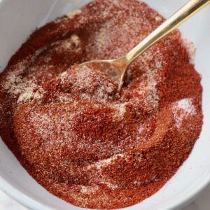 chicken wing seasoning in white bowl with gold spoon