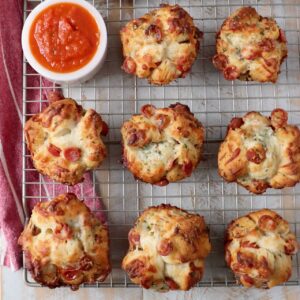 pull apart pizza rolls on wire rack with bowl of marinara sauce