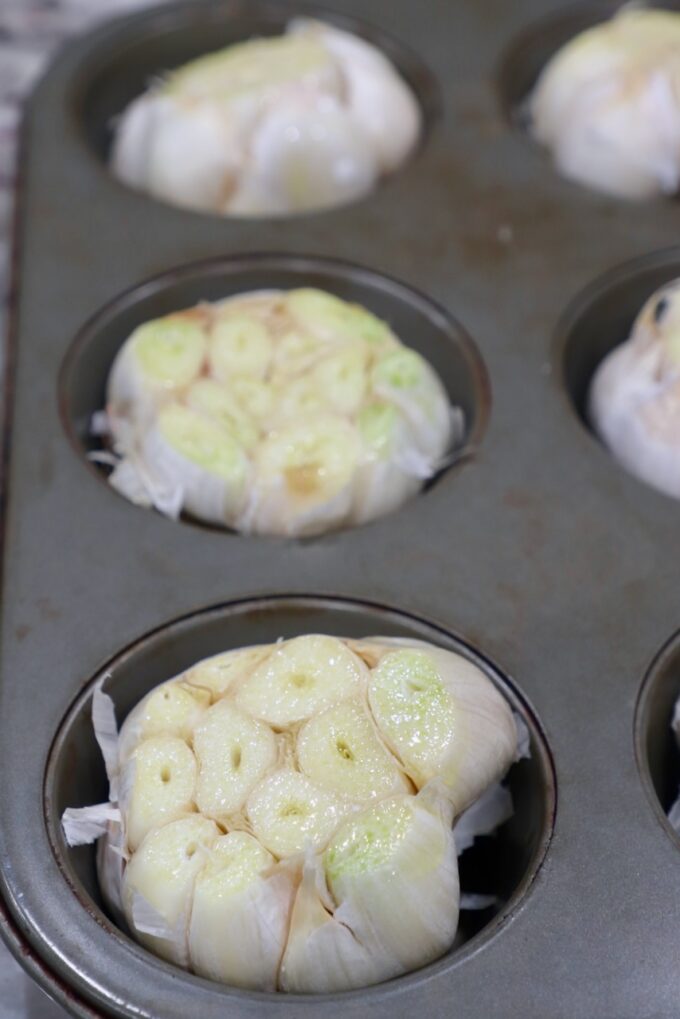 heads of garlic in muffin tin