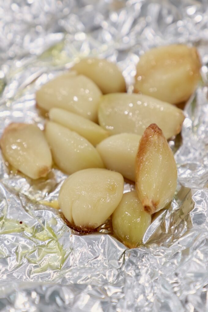 roasted garlic cloves on a piece of foil