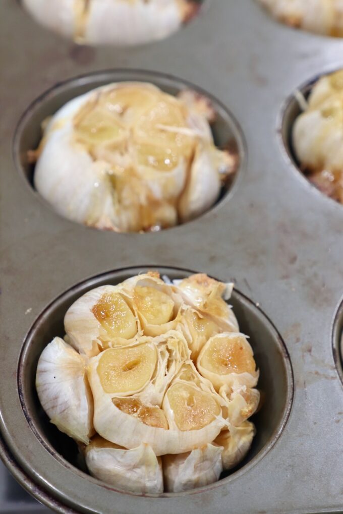 roasted garlic bulbs in muffin tin