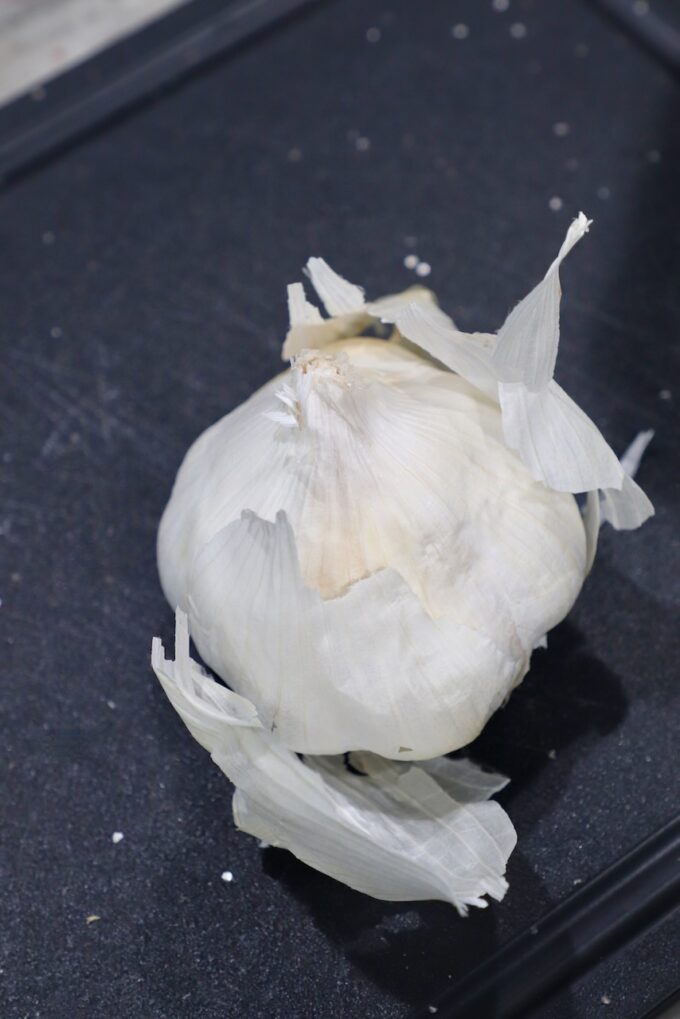 head of garlic with the outer layers peeling off