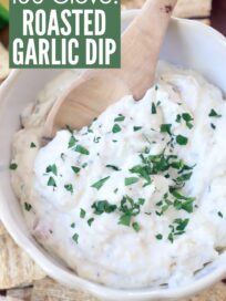 garlic dip in bowl topped with fresh chopped parsley