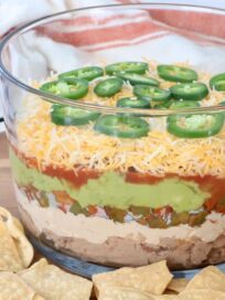 seven layer dip in glass trifle bowl
