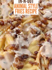 cooked french fries covered with melted cheese, grilled onions and burger sauce