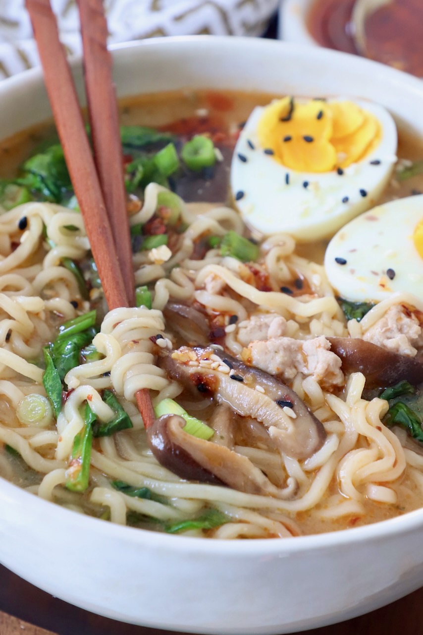 ramen soup in bowl with chopsticks and medium boiled eggs