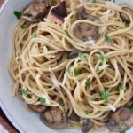 mushroom pasta in bowl with fork