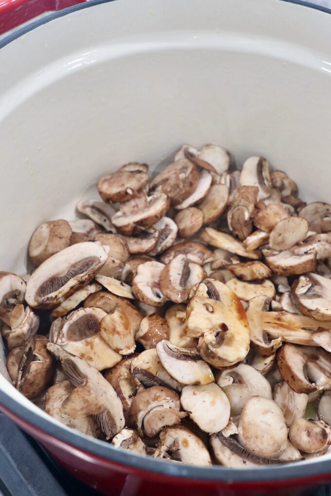 sliced mushrooms in pot with soy sauce