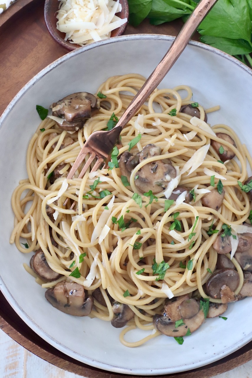 mushroom pasta in bowl with fork