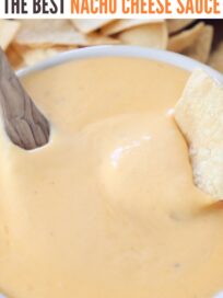 tortilla chip dipped into bowl of nacho cheese sauce