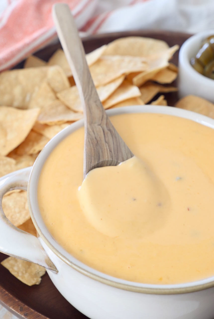 nacho cheese sauce in bowl with spoon