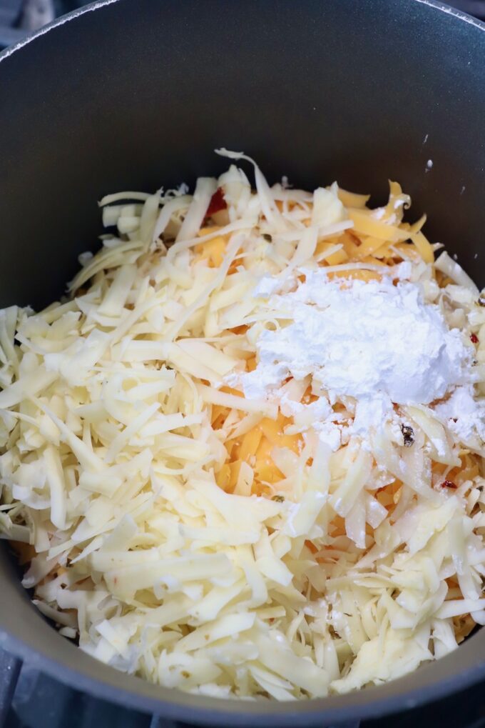 shredded cheese in sauce pot with cornstarch