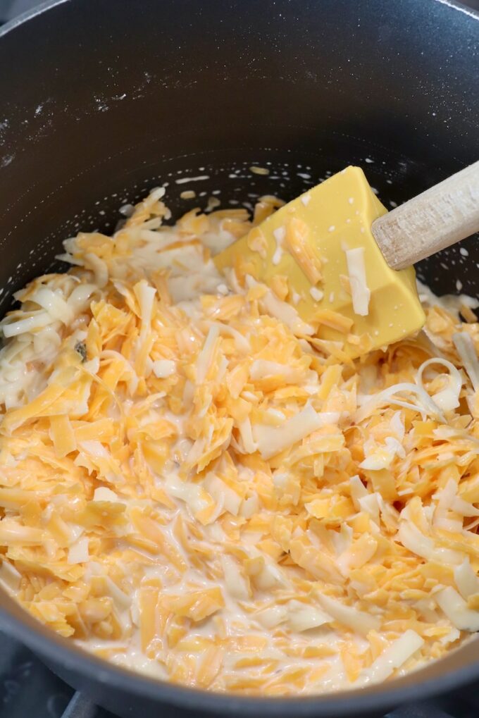 shredded cheese in pan with spatula