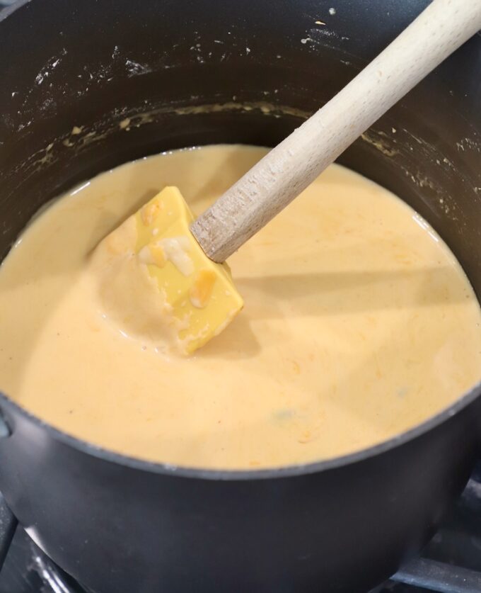 cheese sauce in pan with spatula