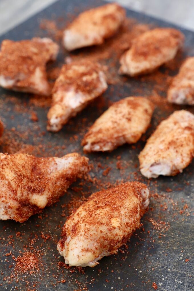 seasoned chicken wings on cutting board